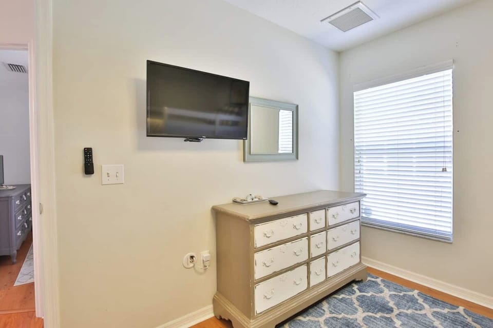 Bedroom with full-over-full bunk beds with a twin trundle and Smart TV