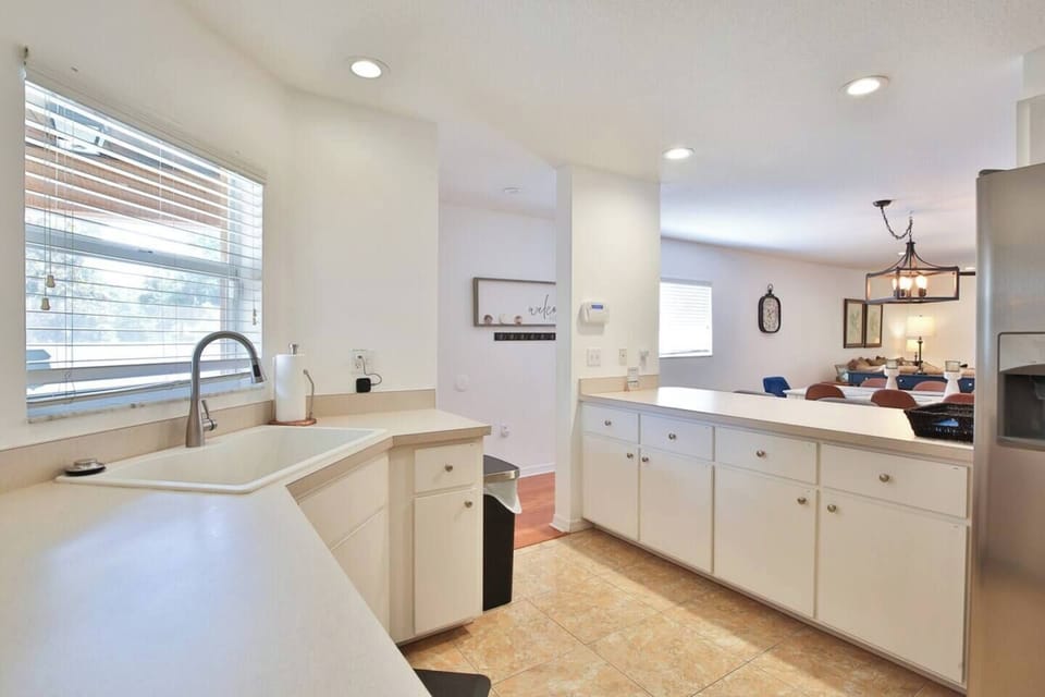 Spacious kitchen with stainless steel appliances and plenty of cooking and baking utensils and tools