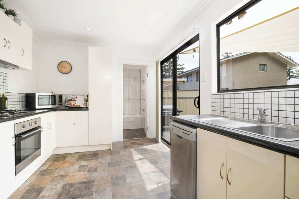 Bathroom, with shower over bath, & laundry