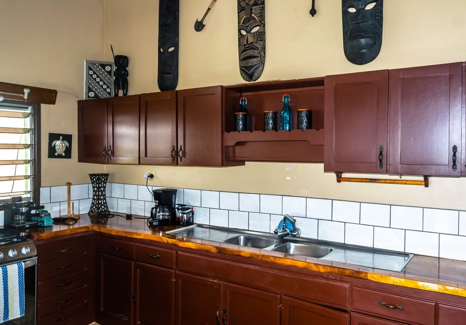 Traditional Fiji style kitchen. Rain Tree wood countertops. Fijian artwork