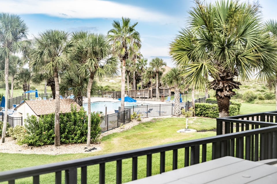 Balcony views of the pool and ocean from the living room
