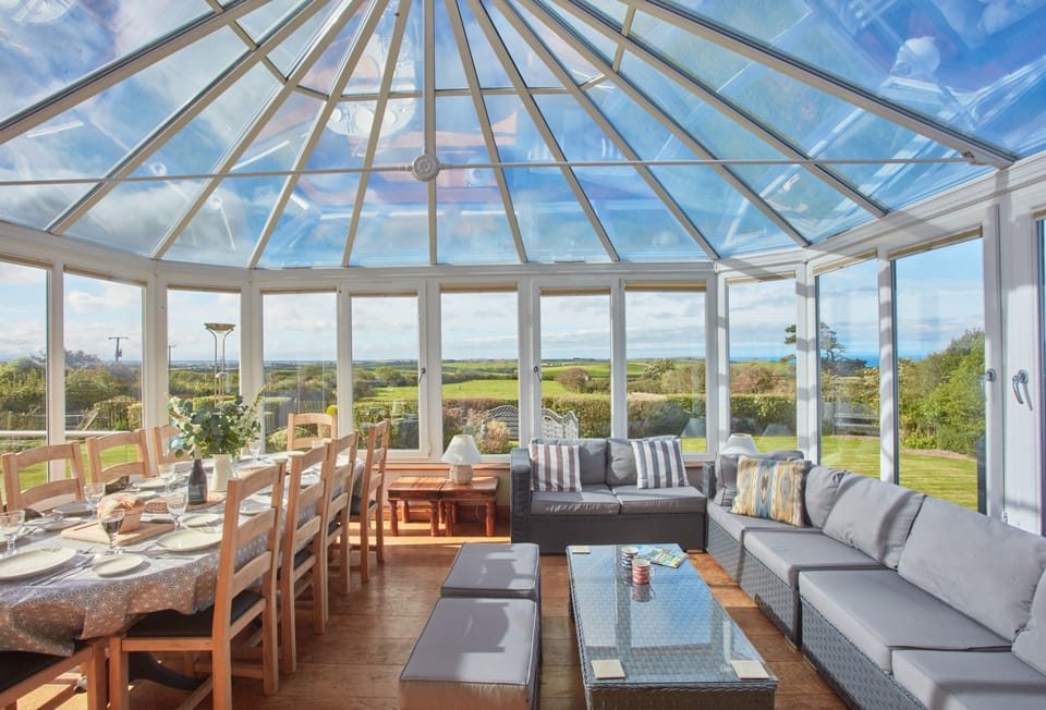 Seawynds, Trelights. Ground floor: Spacious living area in the conservatory with dining area for ten guests. Views overlooking the garden and distant sea views