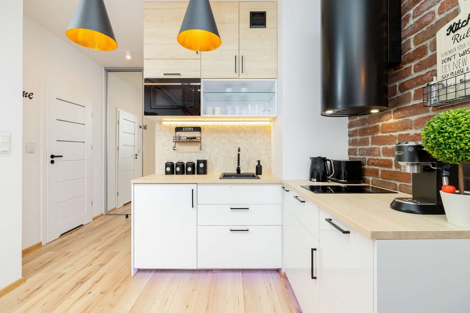 Fully equipped kitchenette with a fridge, kettle, induction hob, microwave, dishwasher and coffee maker.