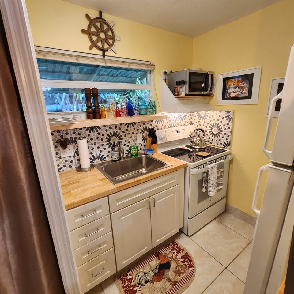 Galley style kitchen with new range and microwave.
