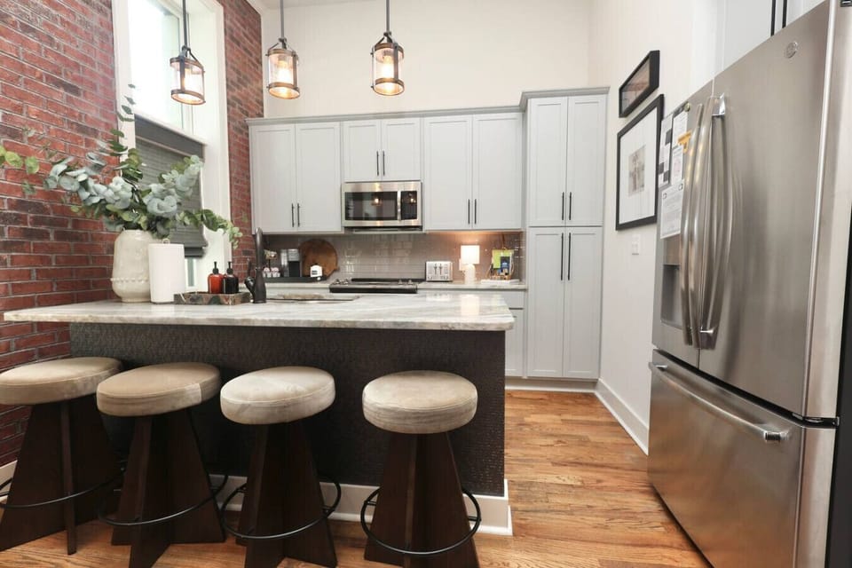 Kitchen: Stylish space with modern finishes, inviting seating, and vibrant natural light!