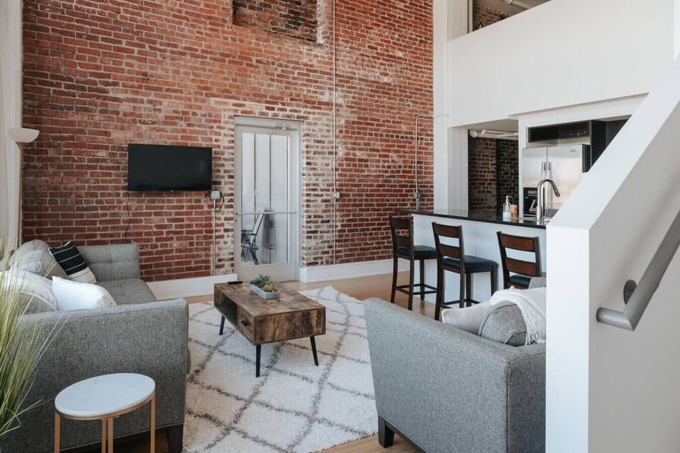 Living Room: Unwind in style with chic decor, exposed brick, and abundant natural light!