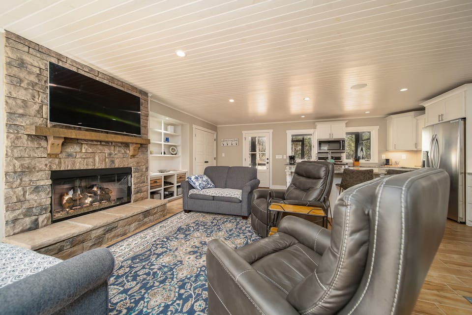 Living Room with Gas Log Fireplace and TV