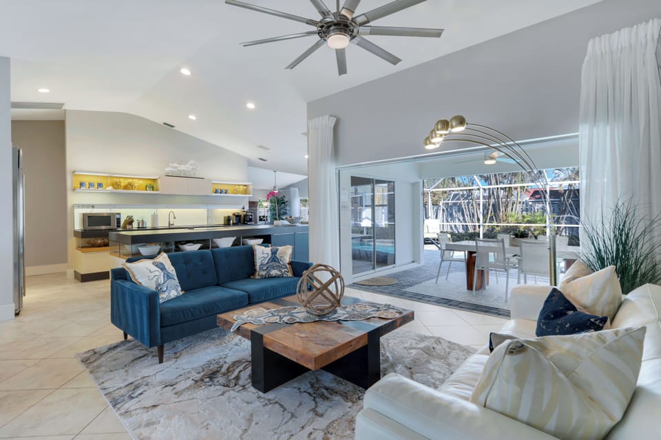 Bright, modern living space with vaulted ceilings and direct access to the lanai for prime indoor-outdoor relaxation