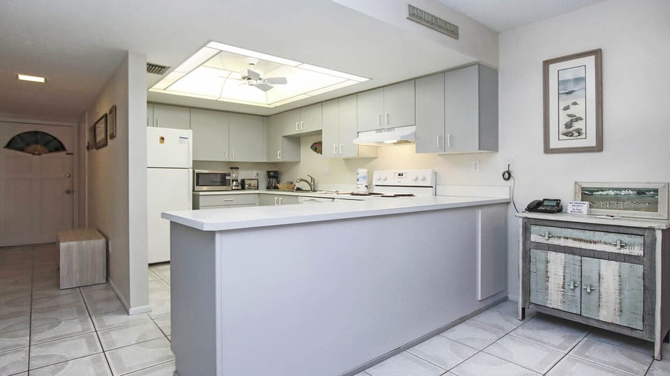 Kitchen with range/oven, microwave, dishwasher, refrigerator/freezer.