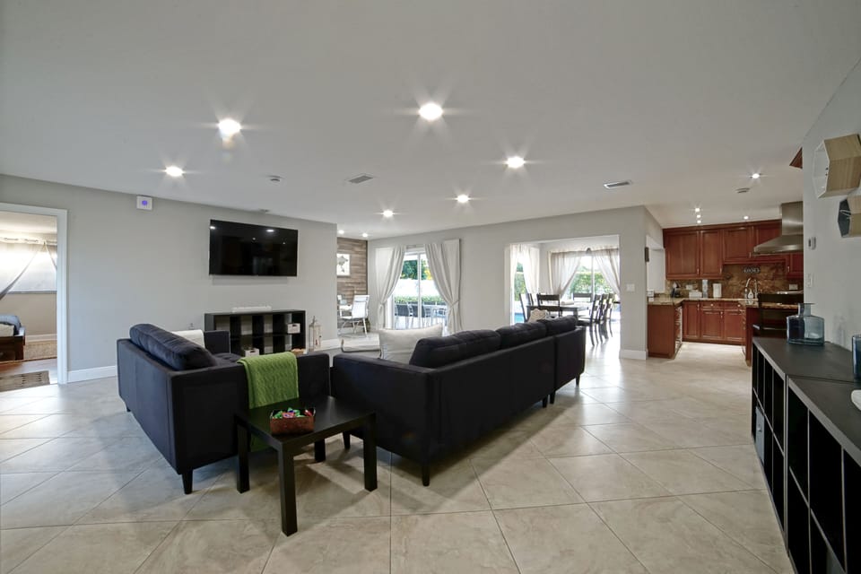 Living-room area with a sectional sofa, a loveseat and smart TV.