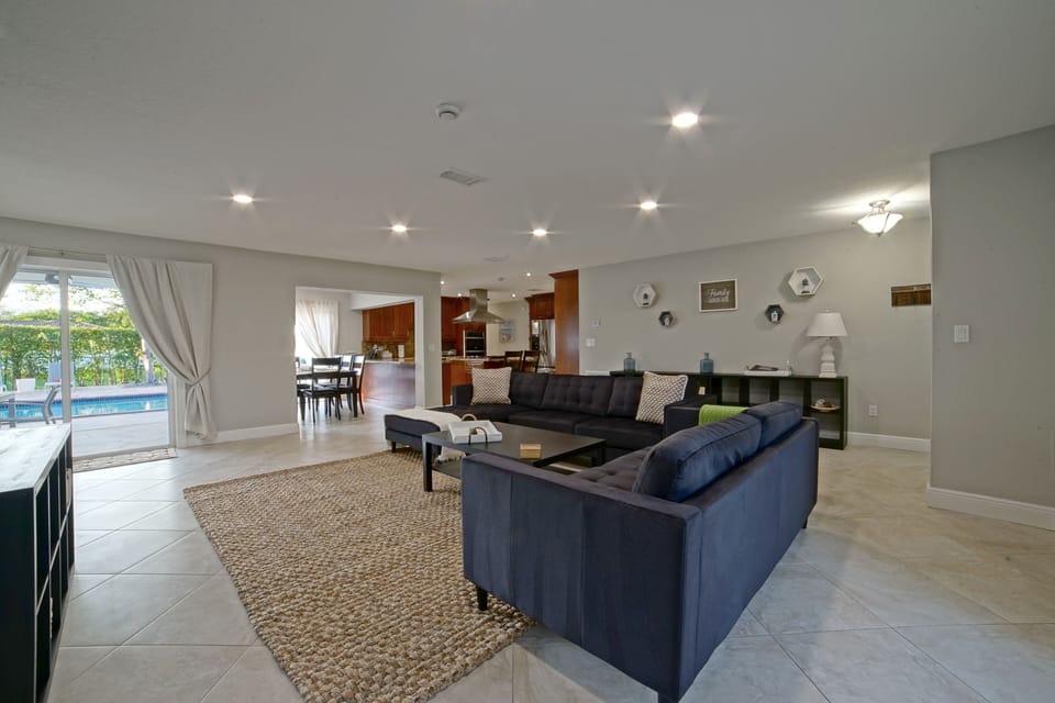 Living-room area with a sectional sofa, a loveseat and smart TV.