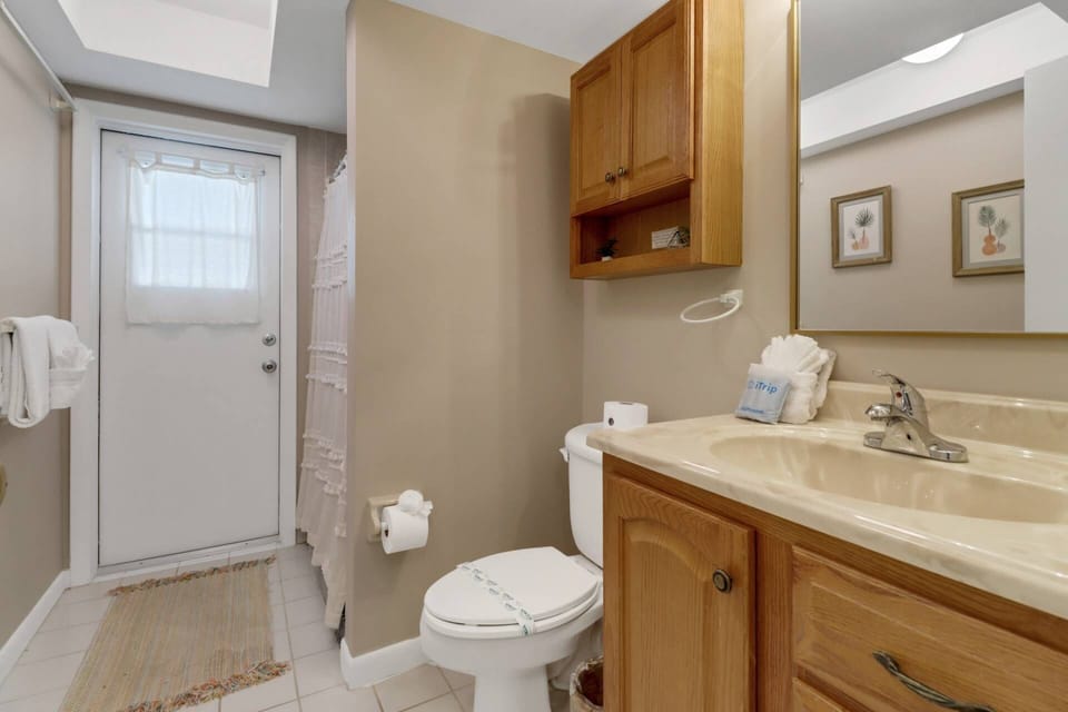 The shared guest bathroom doubles as a pool bath, and features a walk-in shower.