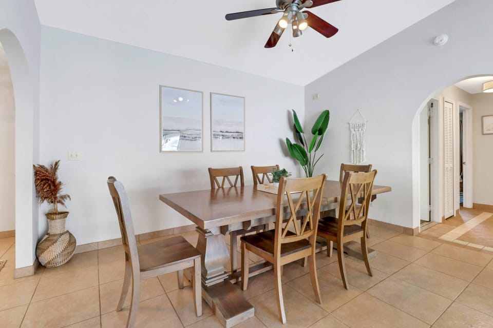 The dining space features a formal table with seating for 6.