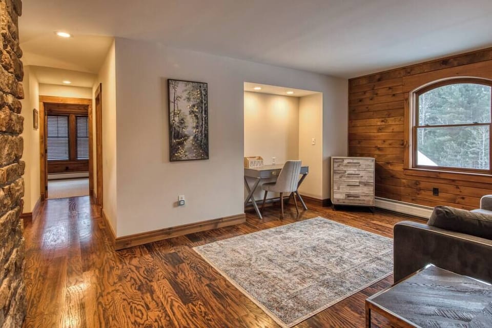 The upstairs loft offers guests a queen sleeper sofa, dresser, and a desk