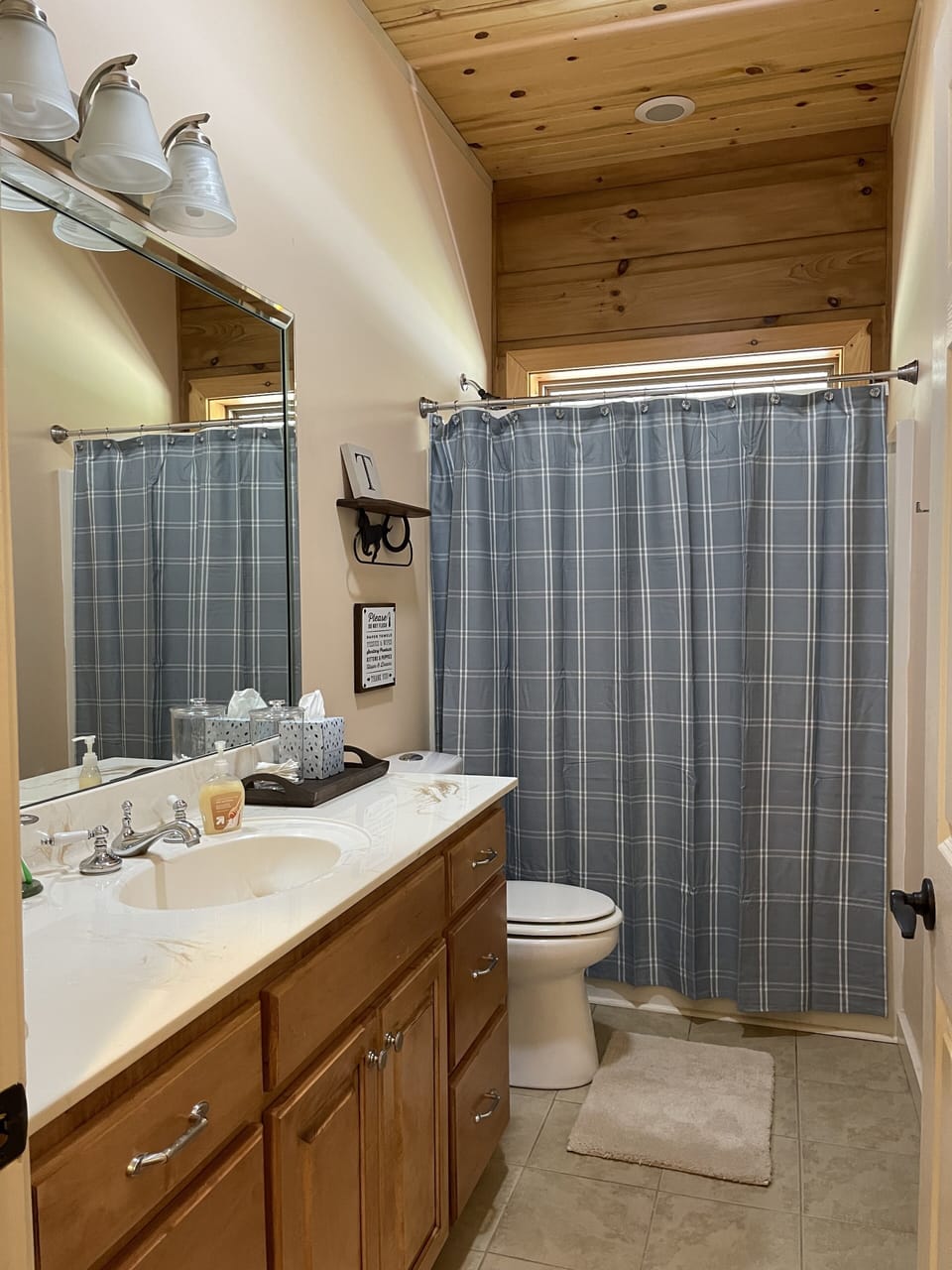Bathroom off main hallway with tub and shower.