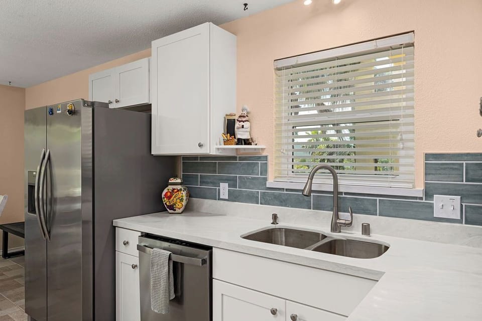 Newly remodeled kitchen with new stainless steel appliances, countertops, backslash and new tile