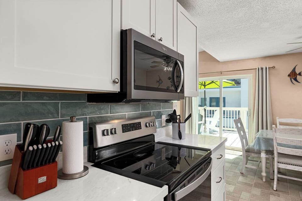 Newly remodeled kitchen with new stainless steel appliances, countertops, backslash and new tile