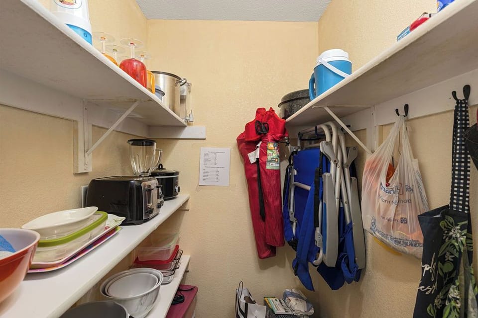 Pantry with kitchen appliances, bowls, food trays and more