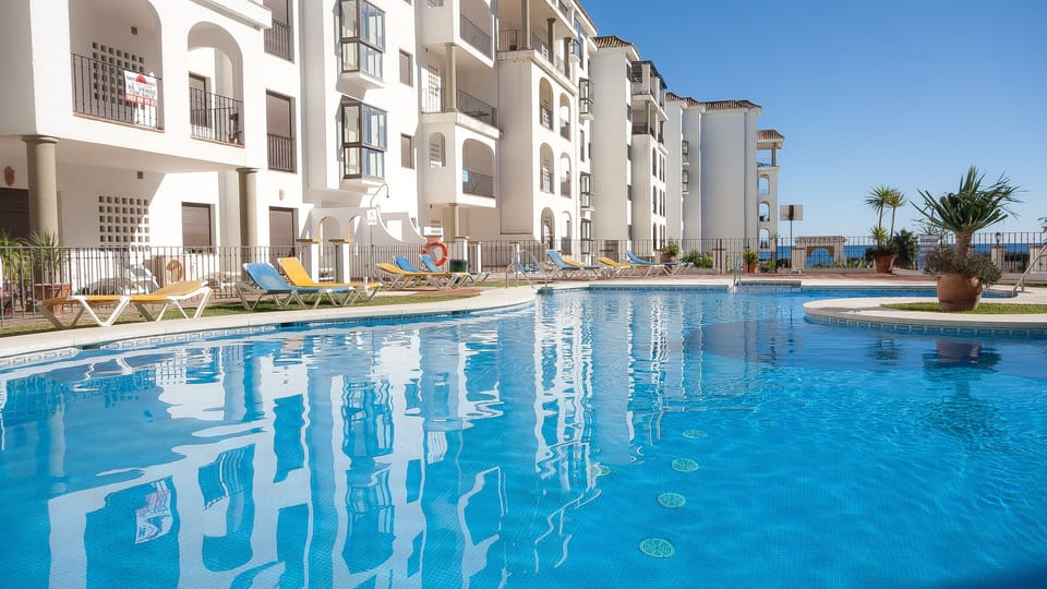 One of four large pools with sunbathing terrace and garden surrounds.