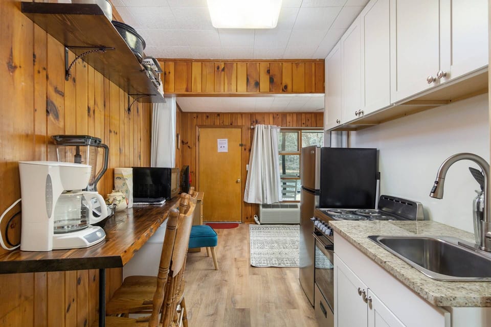 Kitchen is stocked with pots and pans. Everything you'll need to whip up your next meal!