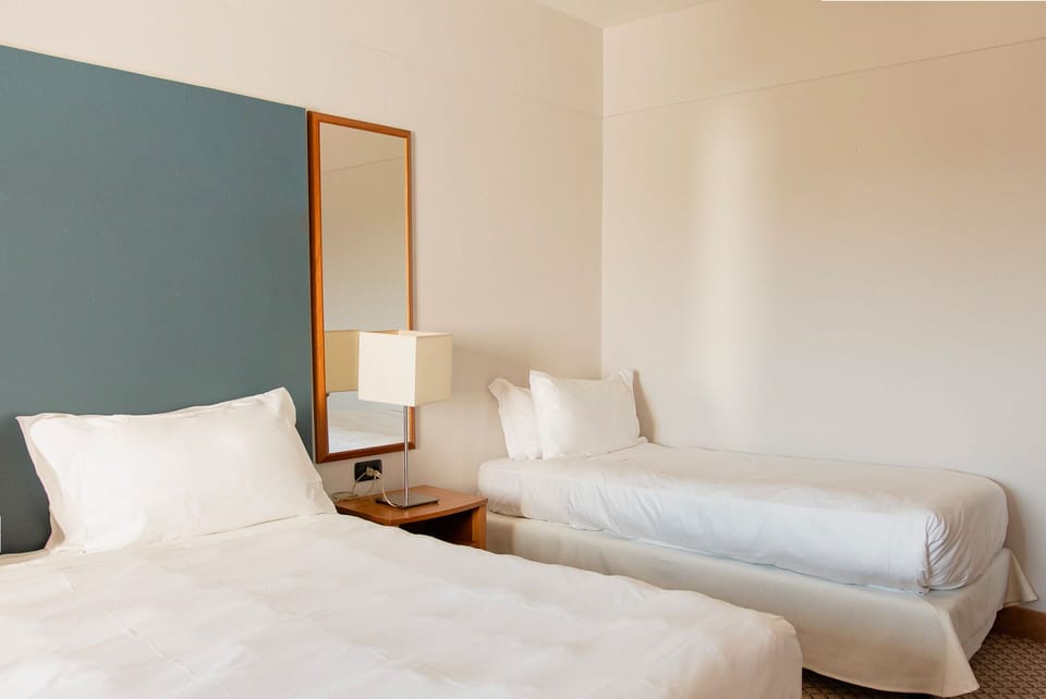 Classic Triple Room | Minibar, desk, laptop workspace, blackout drapes