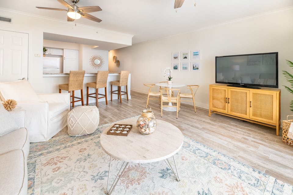 Spacious living room with 50" smart TV, queen sleeper sofa and large arm chair.