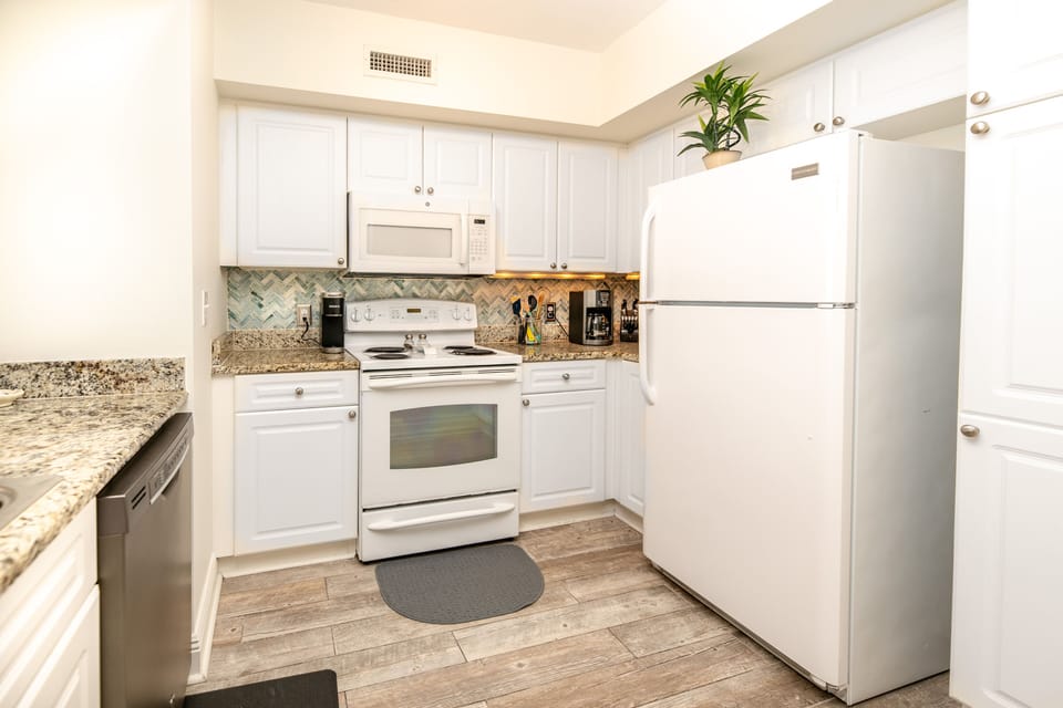 Fully stocked kitchen with Keurig and drip coffee makers.