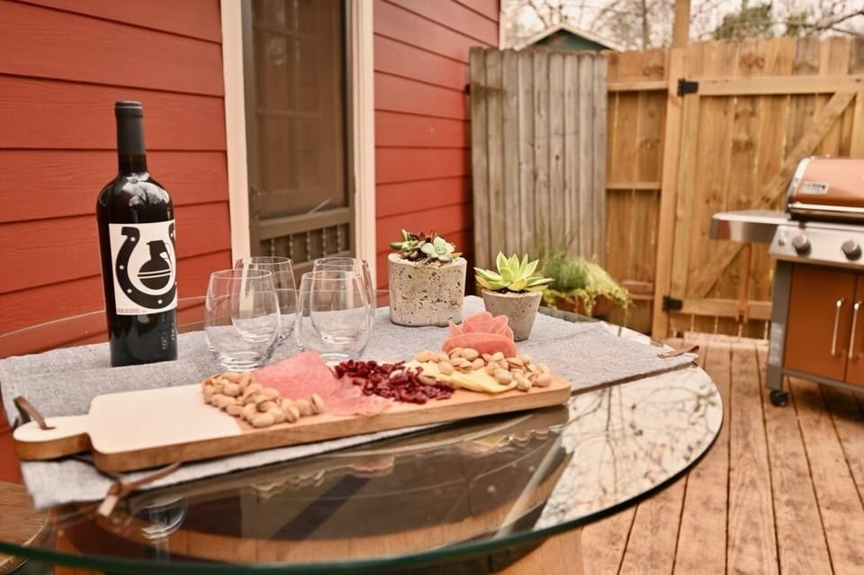 Outdoor entertaining space with a French  barrel cocktail table and bar stools.