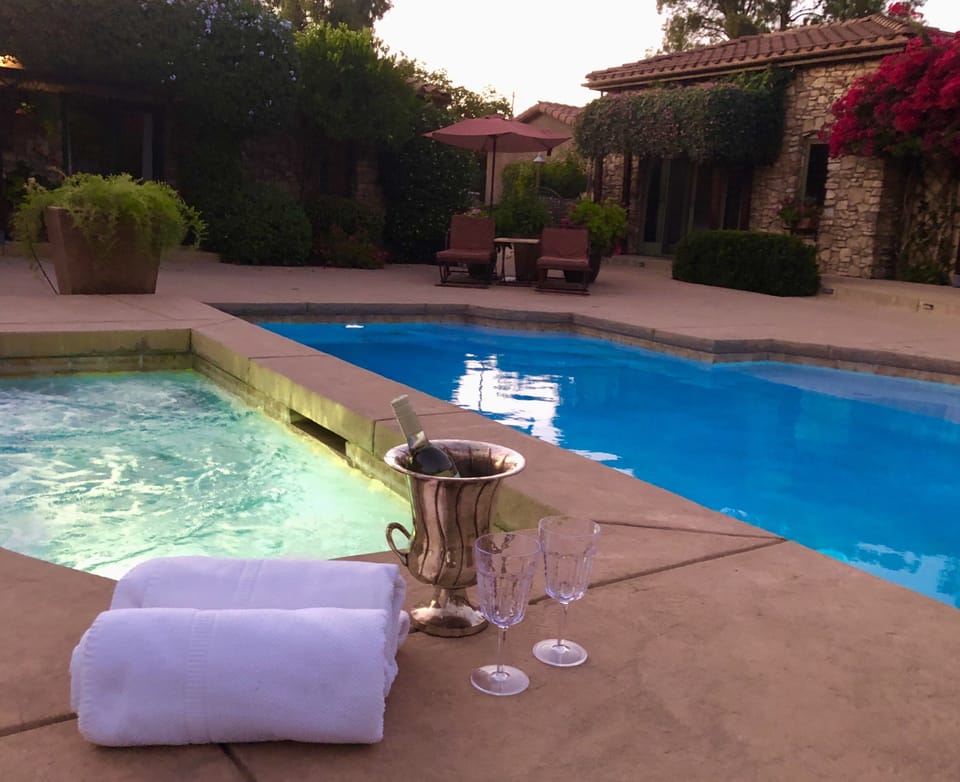 Soak in the spa overlooking the pool and wet deck