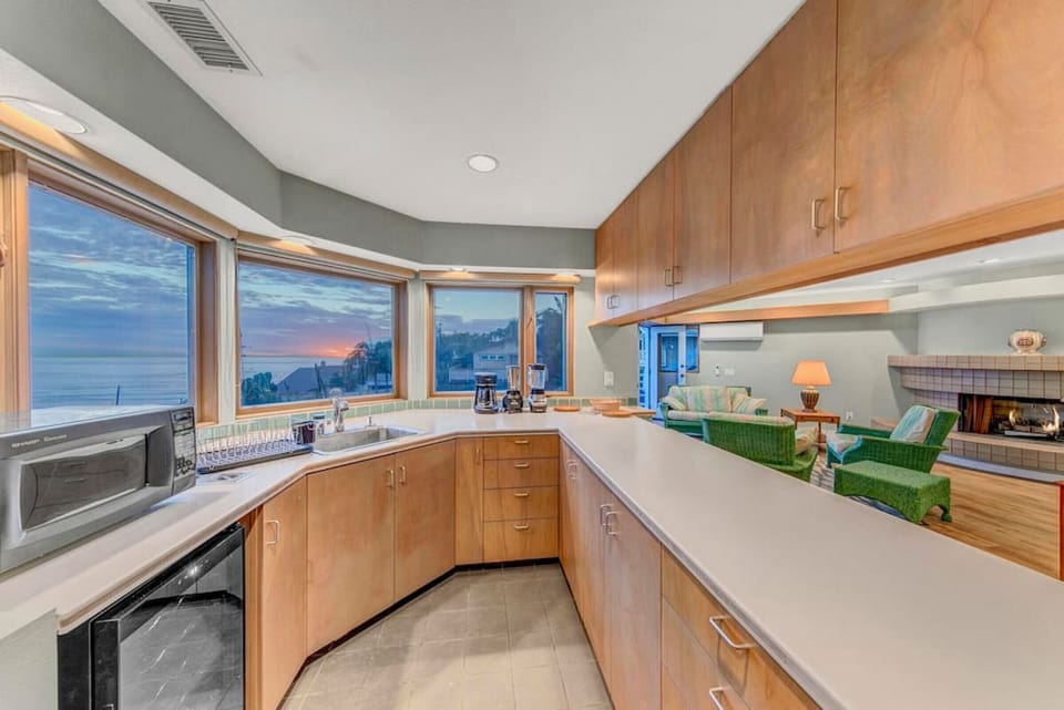 The well-appointed wet bar is the perfect spot to dine or snack. The full kitchen and dining area is downstairs for those extra special meals!
