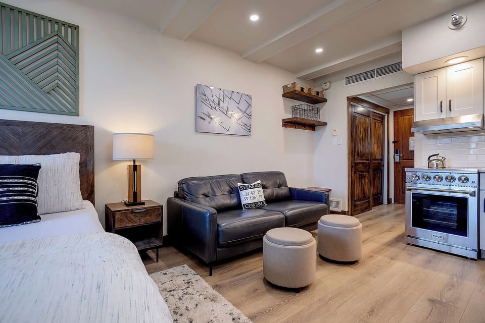 Unwind in your open-plan studio with plush seating, a cozy bed, and a fully equipped kitchen ready for your culinary adventures. Modern comforts meet warm style.