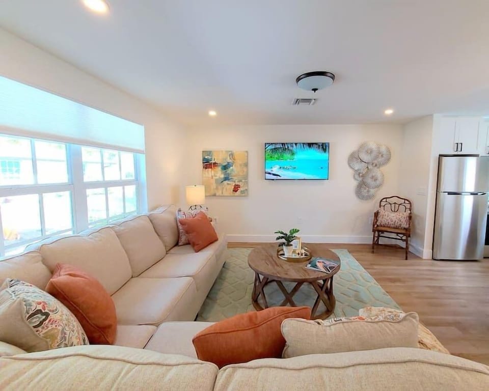 Spacious Livingroom with flat screen tv, throw blanket and plush pillows.  