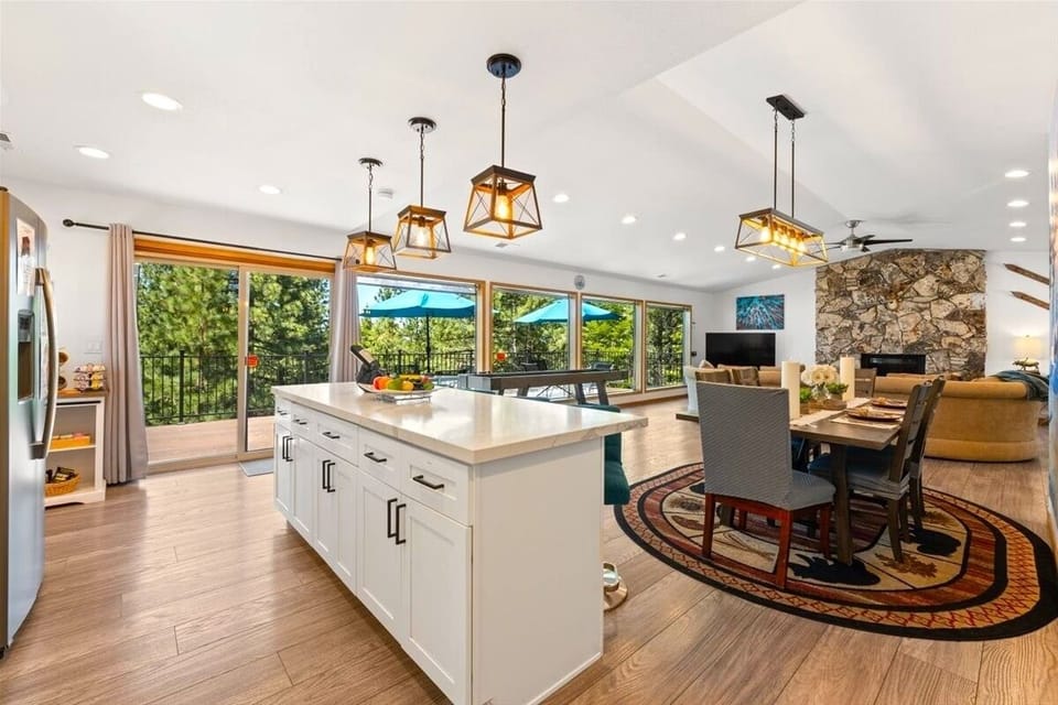 Bright, airy, and designed for groups — this open living space combines a chef-friendly kitchen, dining area, and cozy gathering room under vaulted ceilings.
