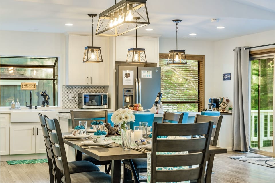 Dining table looking into renovated kitchen with box bay window