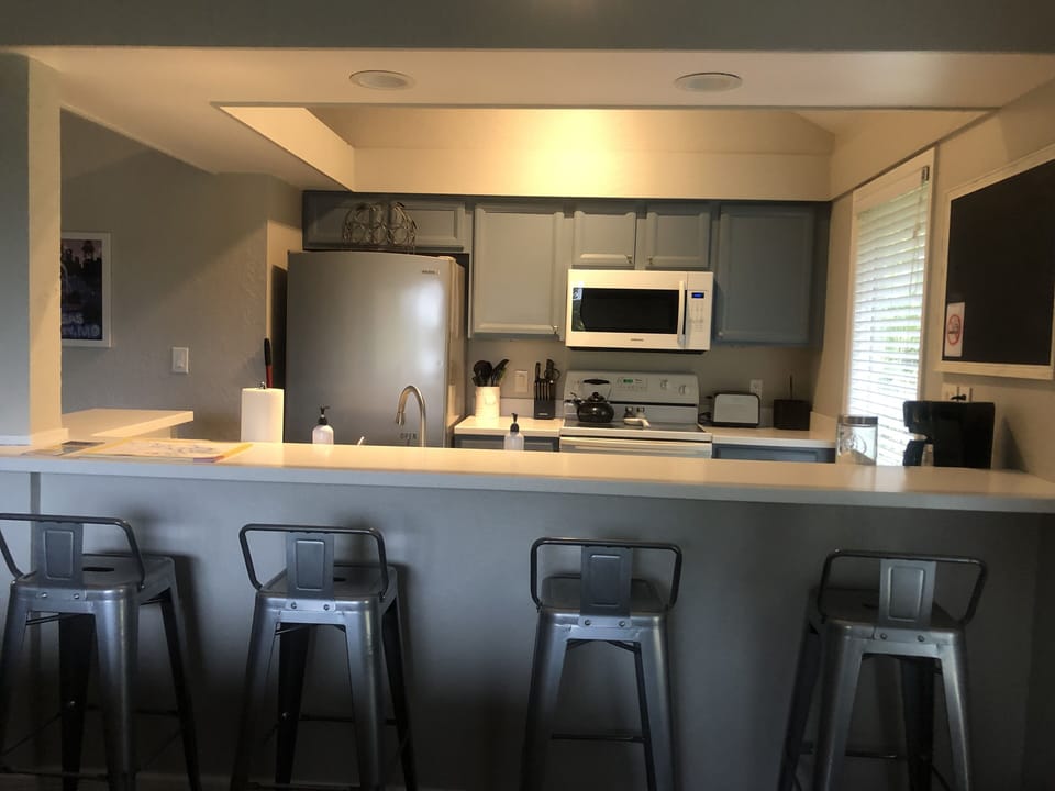 Kitchen with breakfast bar dining area. 