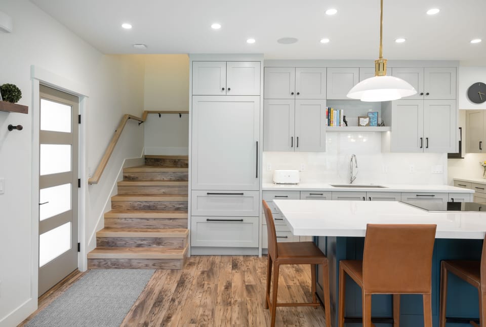 Sub Zero custom refrigerator to the right of the stairs.