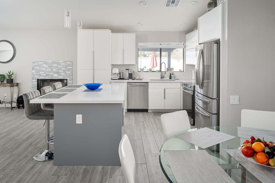 Sleek design throughout this modern chef's kitchen and dining area.