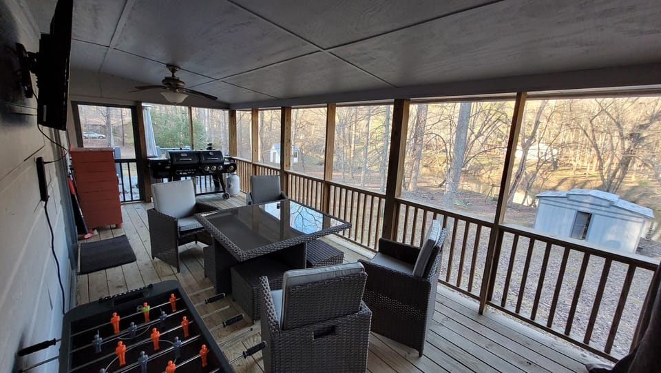 Screened in covered back porch area. Table w/seating for 4 & 50" TV & Foosball