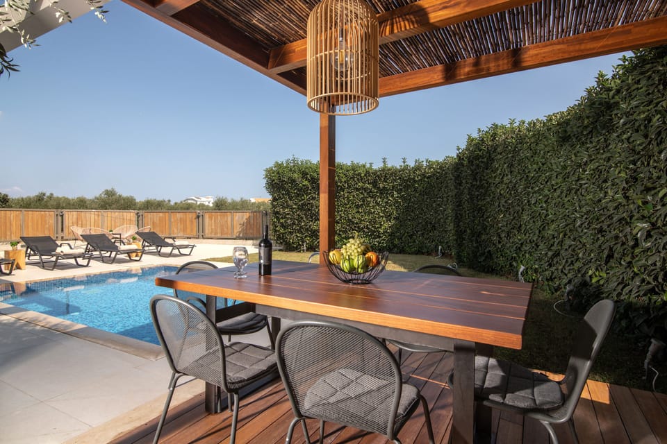 The outdoor dining area features BBQ settings.