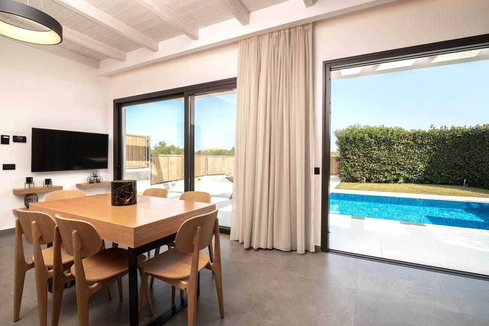 A spacious indoor dinning area awaits you, overlooking the pool.