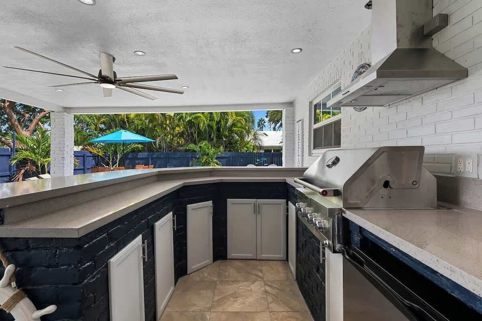 outdoor bar and grill interior - overlooks couch and pool area
