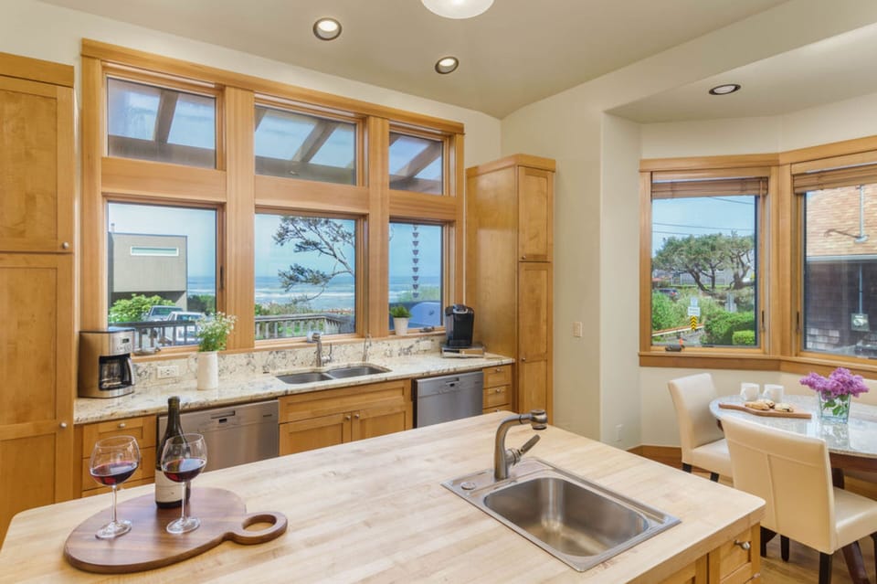 The large kitchen features modern appliances, an island, and a breakfast nook.