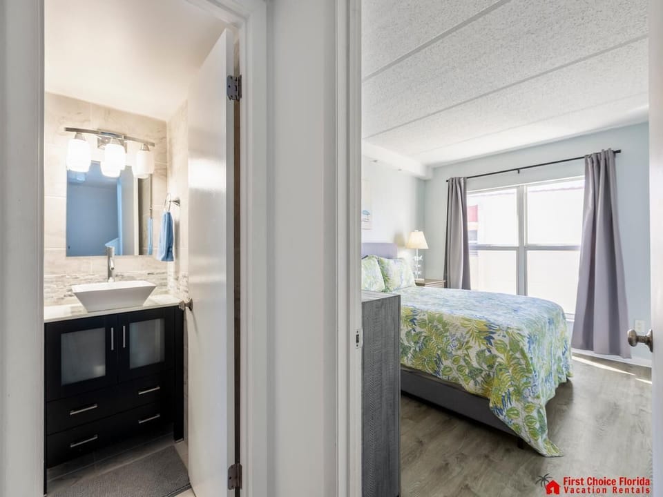 Bright guest bedroom entry with cozy bedding and natural light