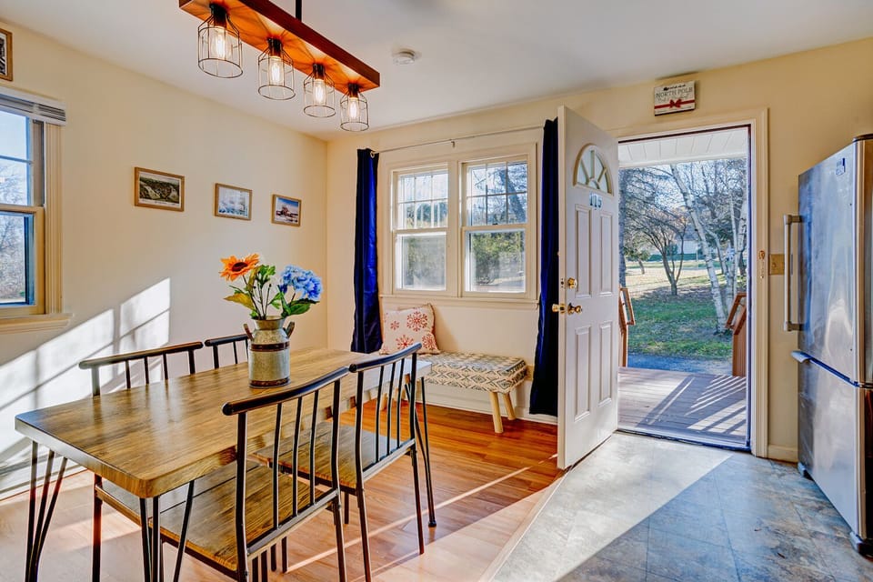 The lovely bright kitchen and dining space with a custom chandelier