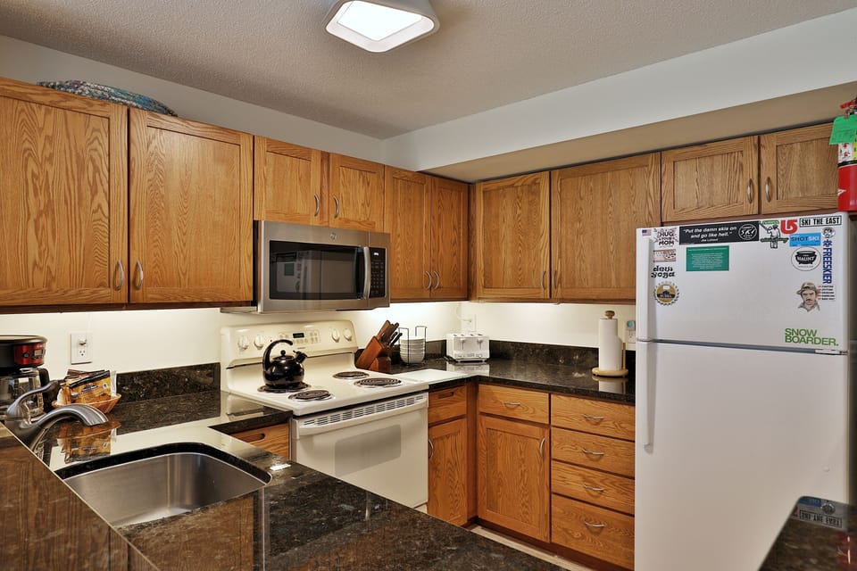Fully equipped kitchen with granite countertops.