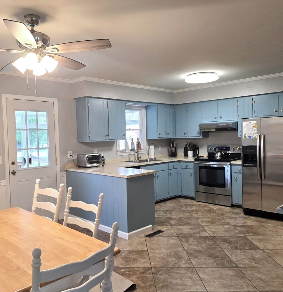 Kitchen with cookware, dishes and utensils.