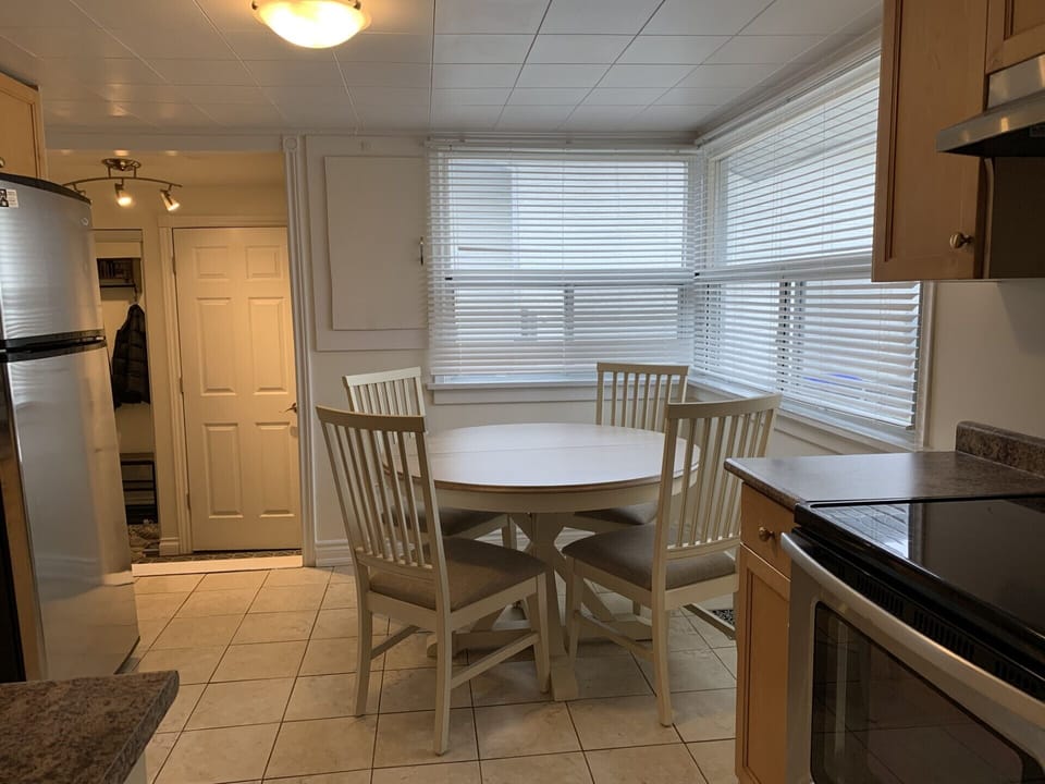 Table with 4 chairs. There are 2 addiitonal fold up chairs and 4 stools