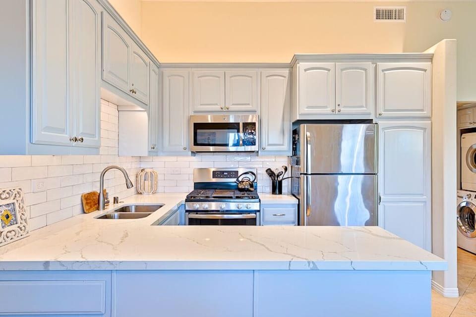 Keurig with complementary coffee and tea stored in the cabinet
