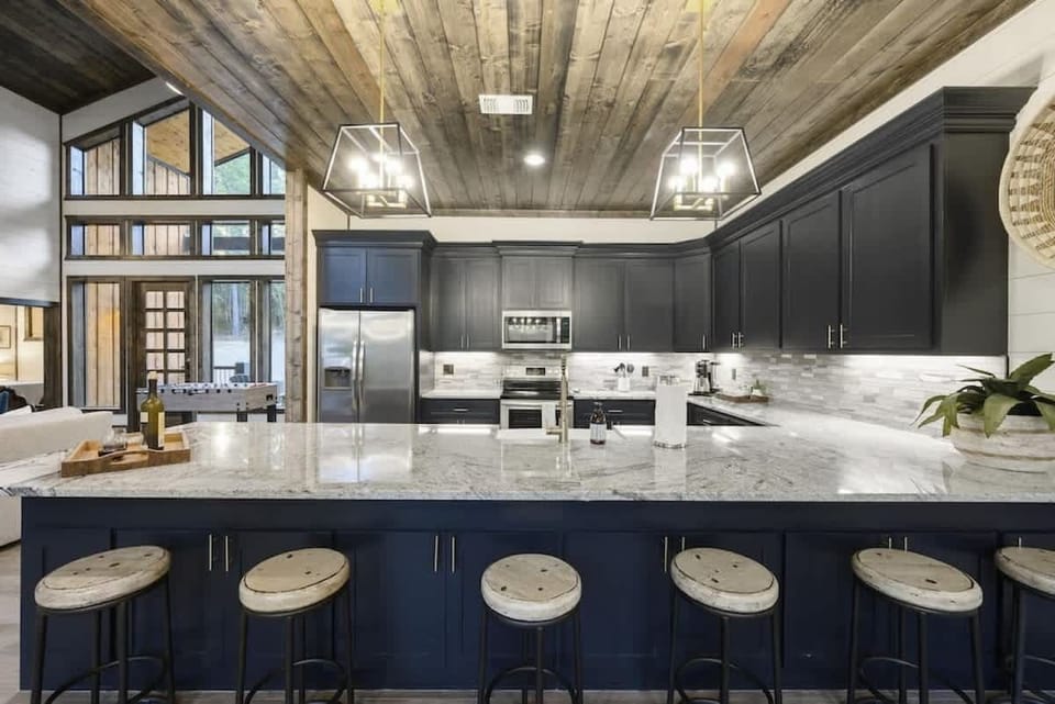 Chef's kitchen with bar seating and granite countertops