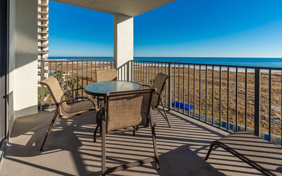 Balcony seating offers a serene view of the gulf and beach, perfect for relaxing in the warm sun